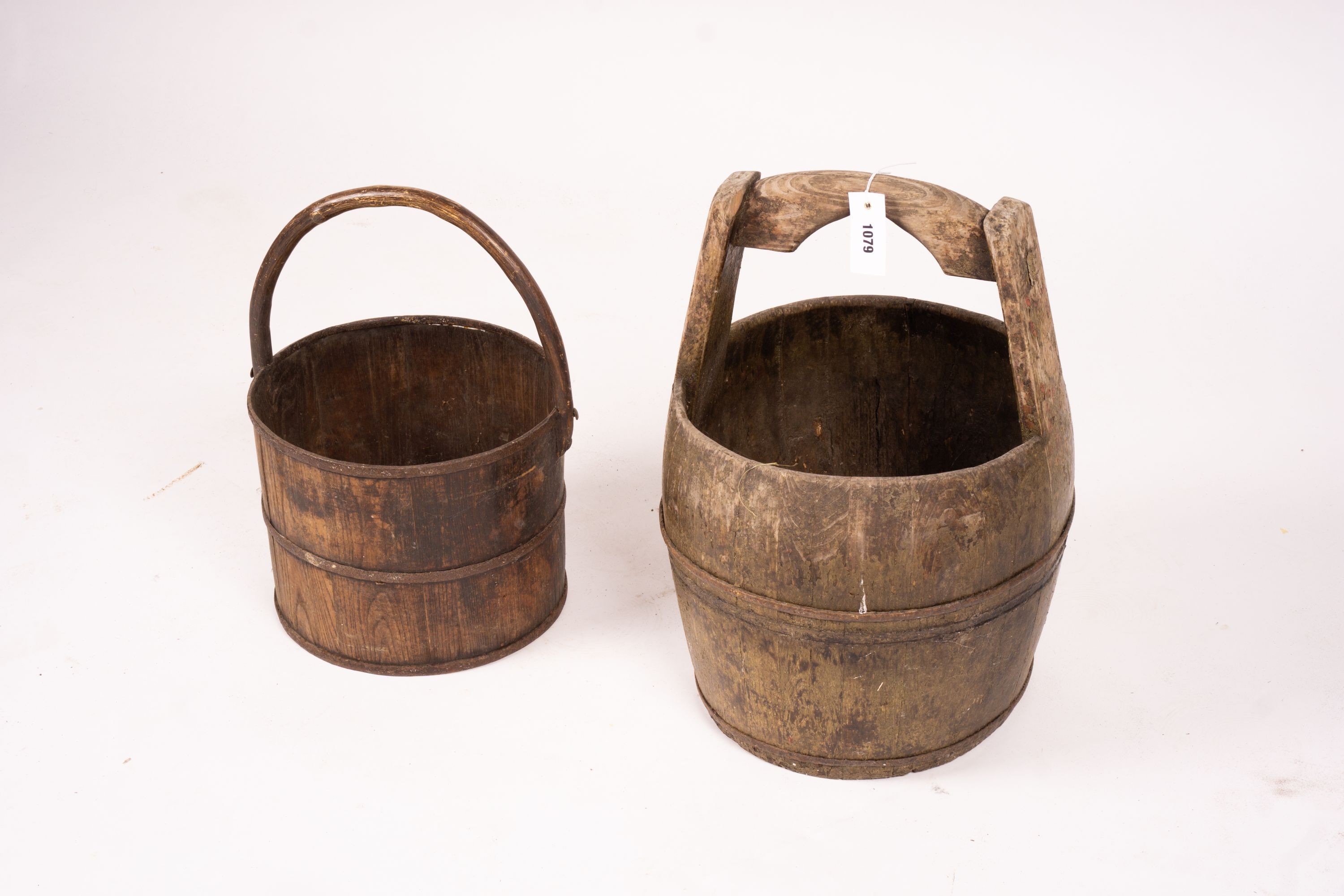 A Chinese staved wood rice carrier together with a circular iron bound staved wood bucket, larger 35cm diameter, height 52cm